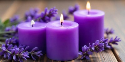 Three purple candles are lit, surrounded by lavender