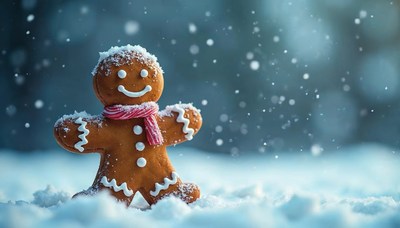 Gingerbread man standing in snow during winter season