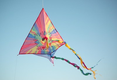 Colorful kite flying against a clear blue sky