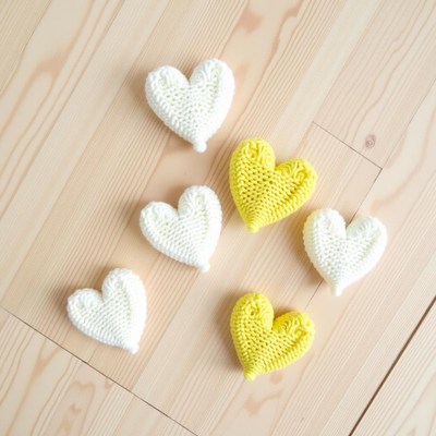 Handmade knitted hearts in white and yellow colors
