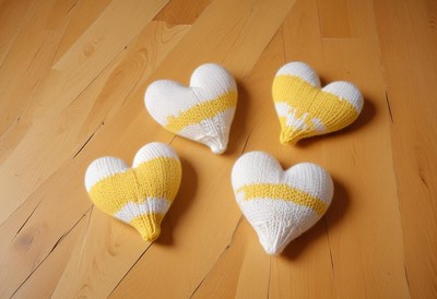 Beautifully displayed yellow and white knitted hearts