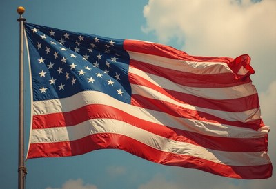 American flag waving against a clear blue sky