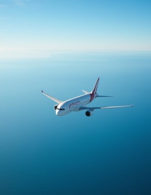 Airplane soaring over tranquil blue ocean waters