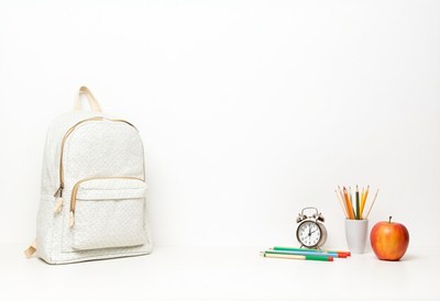 School supplies and backpack on a clean desk setup