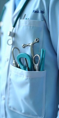 Medical tools in doctor's coat pocket during procedure
