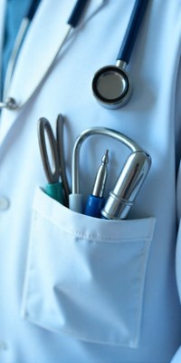 Medical tools stored in a doctor's white coat pocket