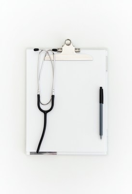 Stethoscope and pen on a white clipboard