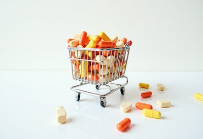 Mini shopping cart full of various pills