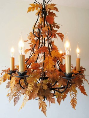 Charming autumn chandelier with natural leaves and lights