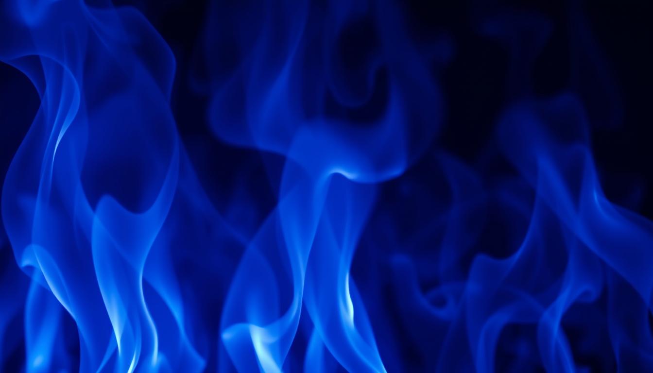 Blue flames dance against a black background Blue flames dance against a black background