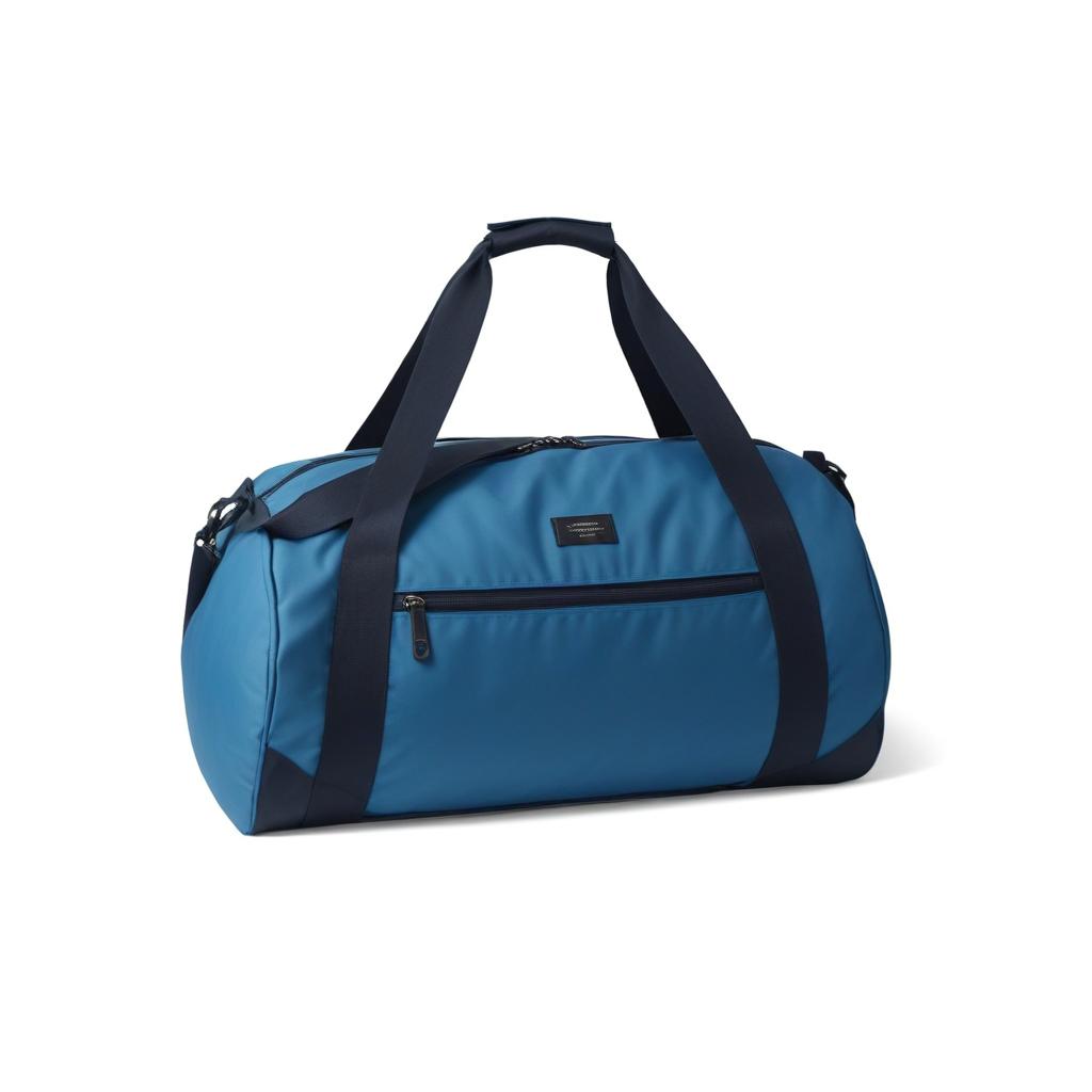 A blue duffel bag with black straps is ready for travel A blue duffel bag with black straps is ready for travel