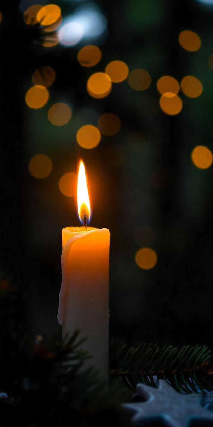 A lit candle stands tall amidst a dark, green background A lit candle stands tall amidst a dark, green background