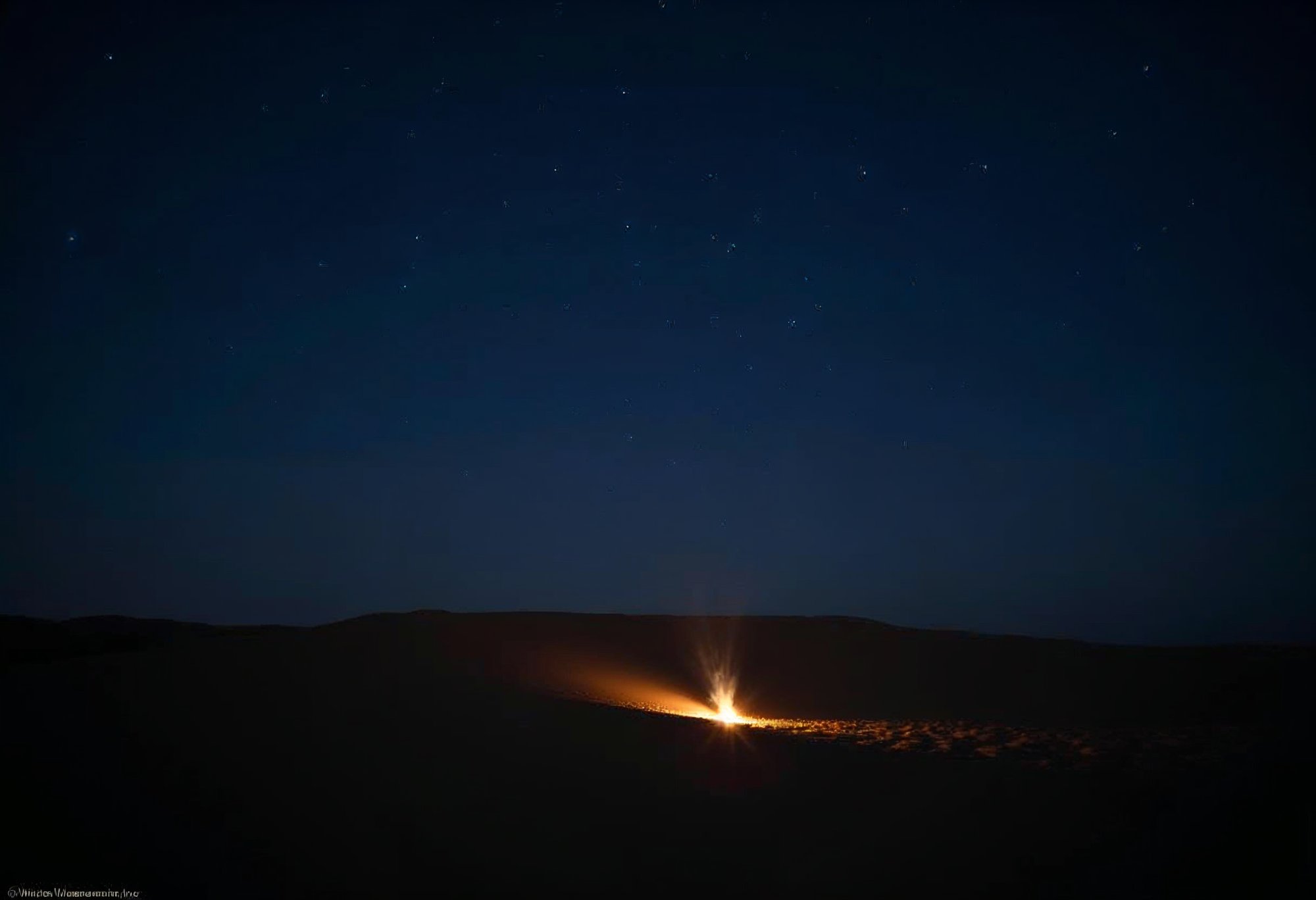 Campfire flickering under a starry night sky Campfire flickering under a starry night sky