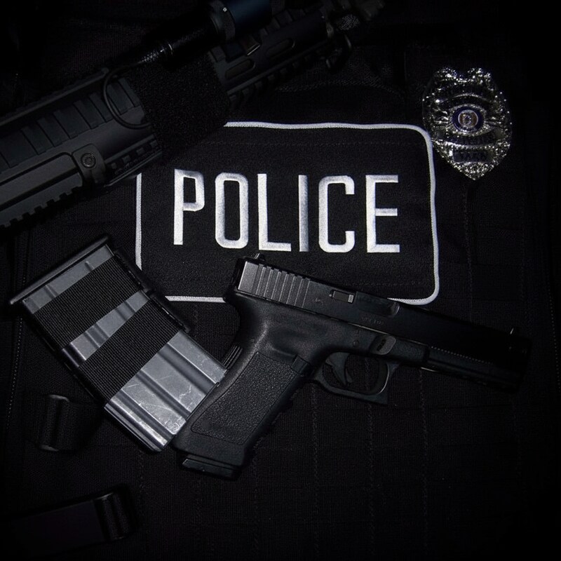 Police gear displayed with firearm and equipment Police gear displayed with firearm and equipment