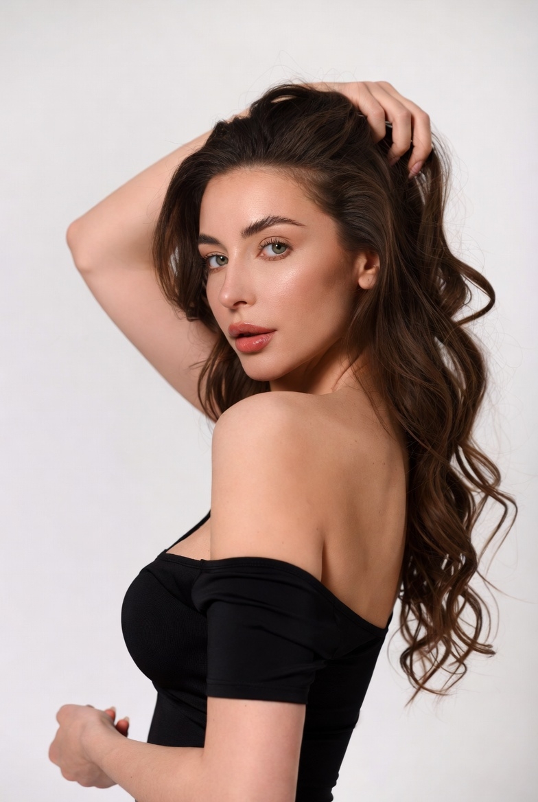 Elegant woman posing with wavy hair against simple backdrop Elegant woman posing with wavy hair against simple backdrop