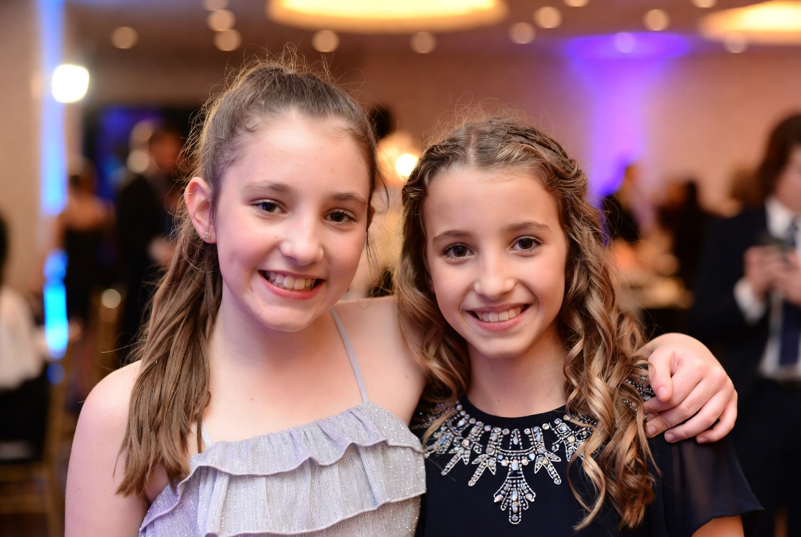 Two smiling girls enjoying a special event together Two smiling girls enjoying a special event together