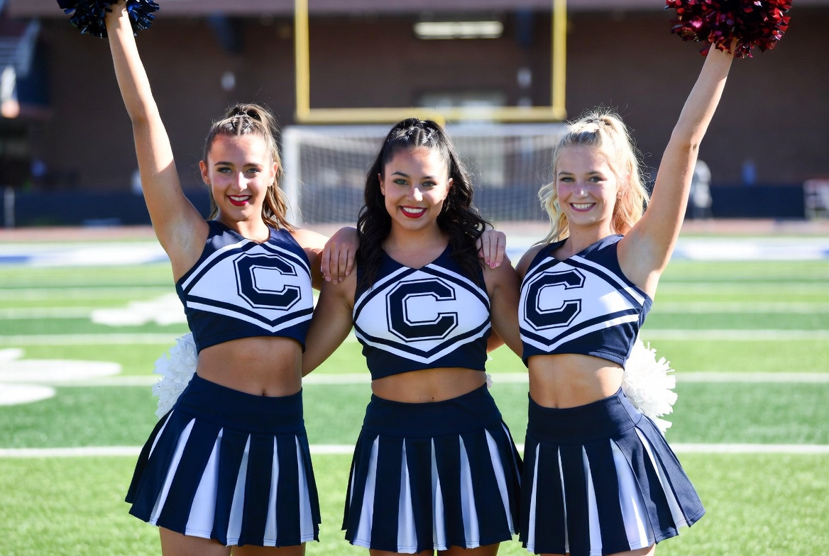 Cheerleaders posing on the field Cheerleaders posing on the field