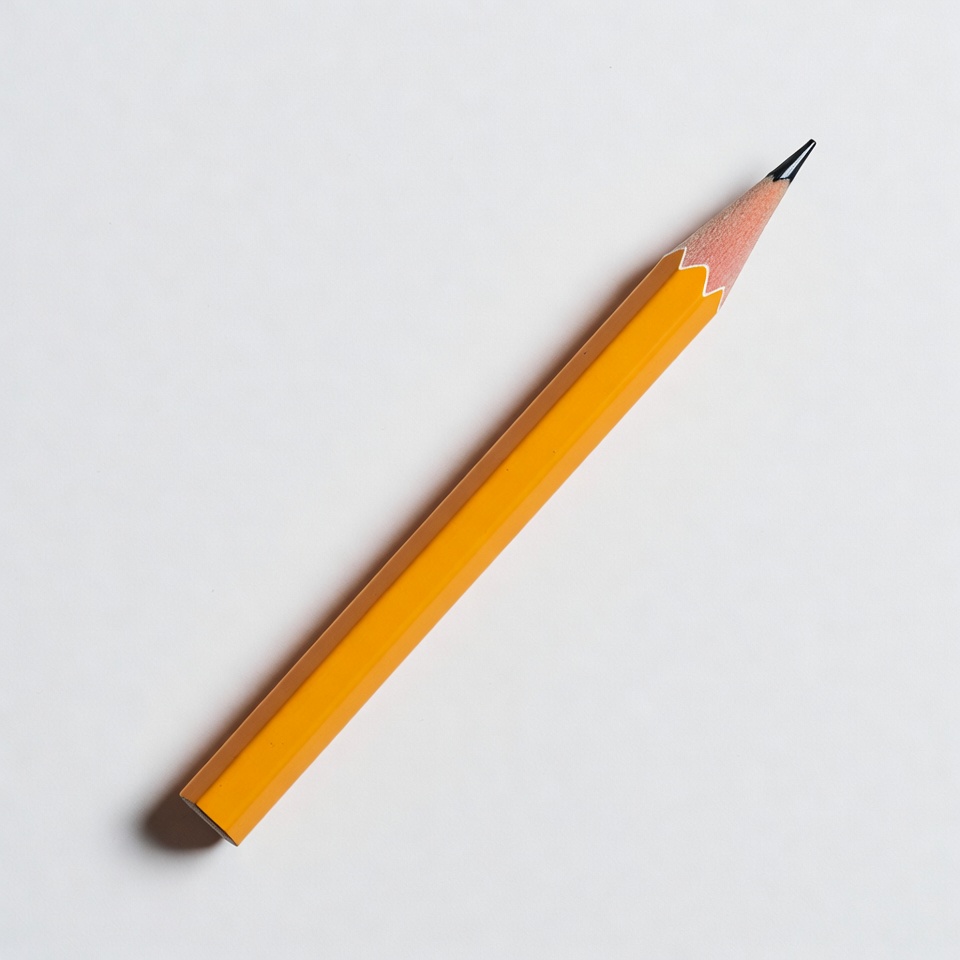 Bright yellow pencil on plain background Bright yellow pencil on plain background