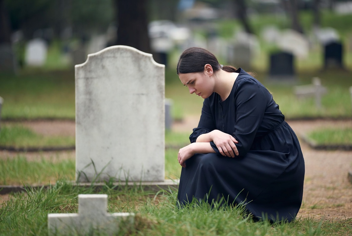 Grieving woman visits cemetery alone Grieving woman visits cemetery alone
