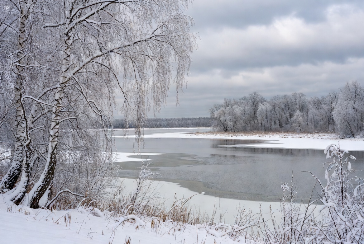 Winter river landscape in gray sky Winter river landscape in gray sky