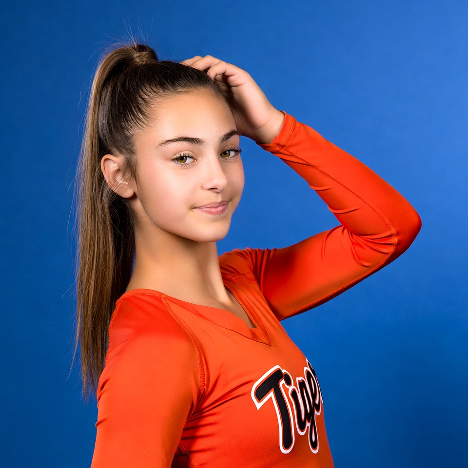 Cheerleader poses against blue background Cheerleader poses against blue background