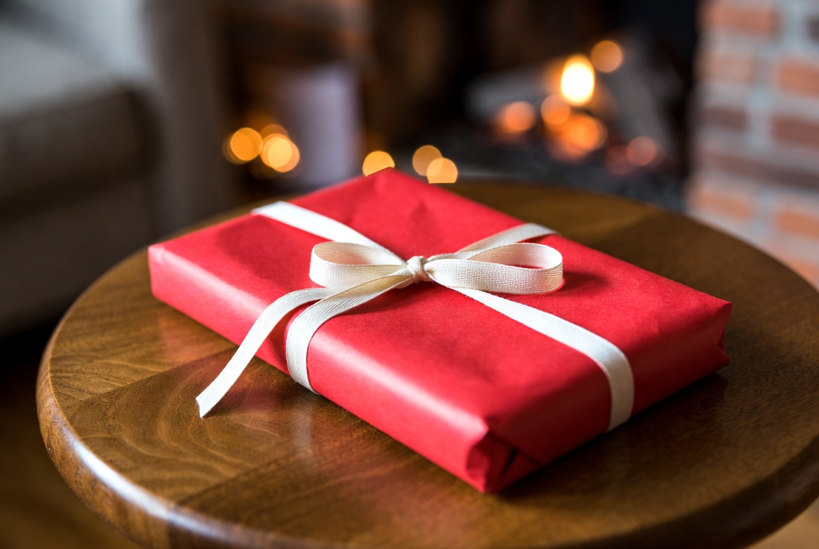 Gift wrapped in red on a table Gift wrapped in red on a table