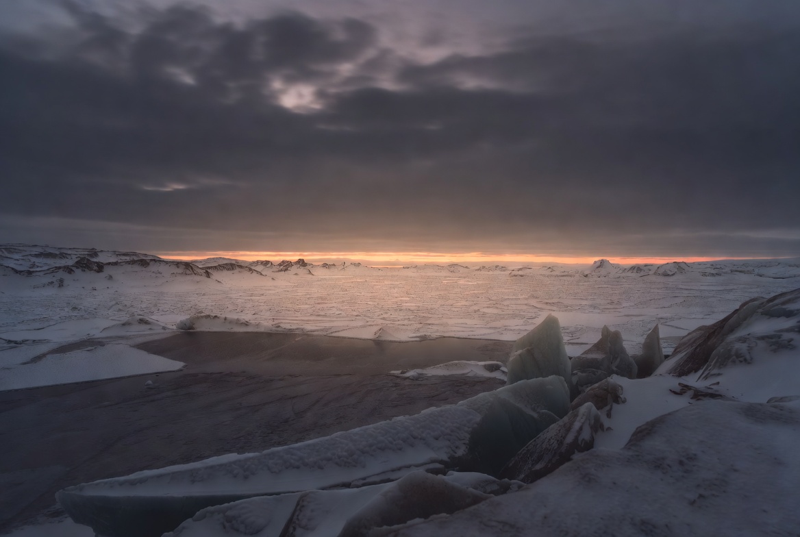 Snowy landscape under dark skies Snowy landscape under dark skies