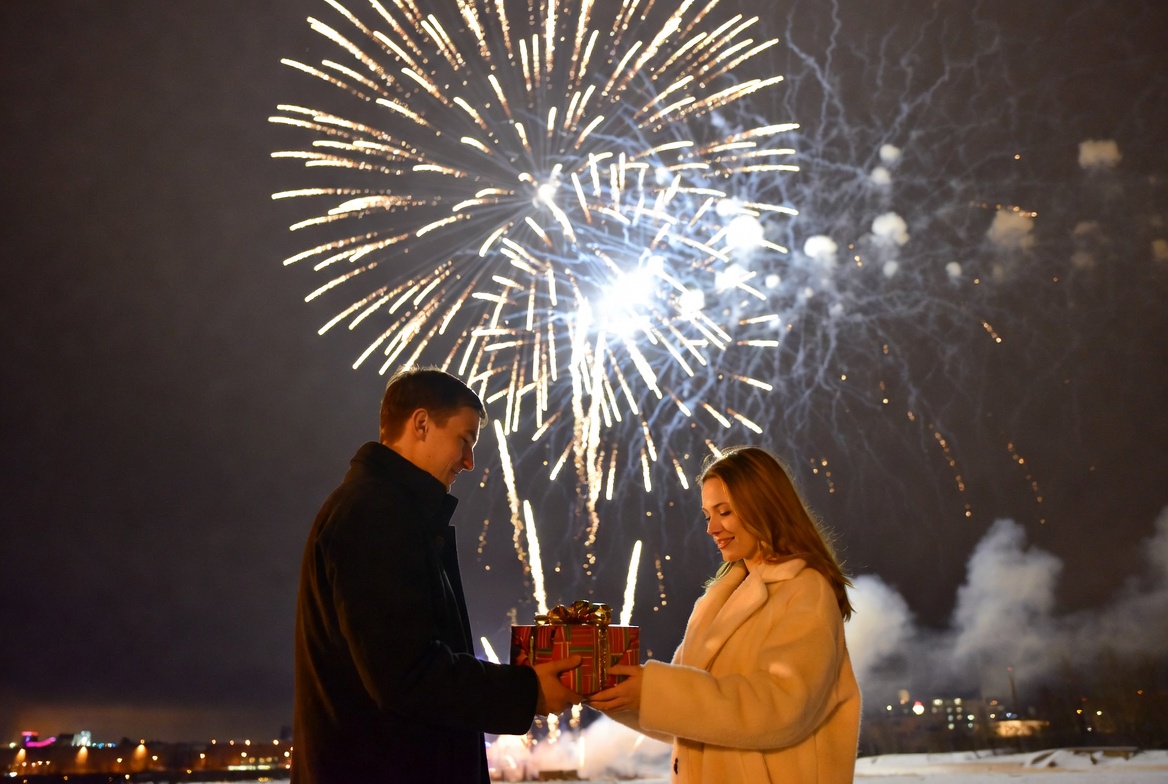 Couple celebrating with fireworks at night Couple celebrating with fireworks at night
