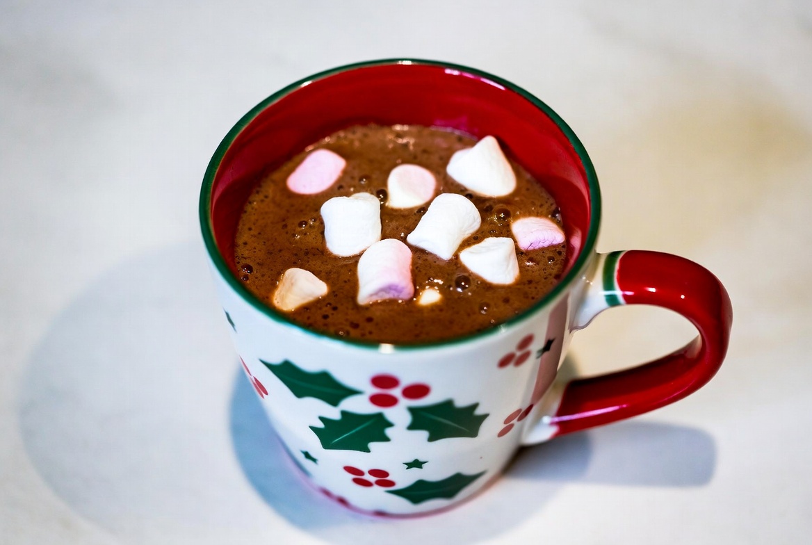 Warm cocoa with marshmallows in festive mug Warm cocoa with marshmallows in festive mug