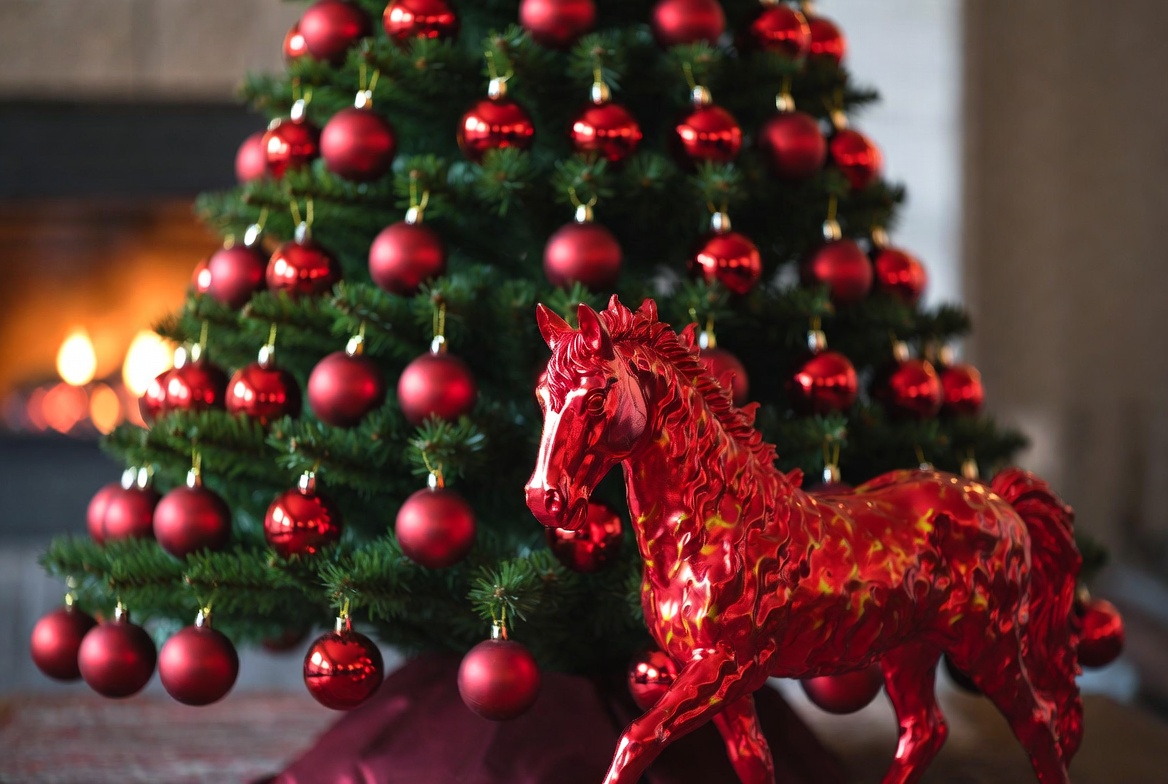 Decorative red horse by christmas tree Decorative red horse by christmas tree