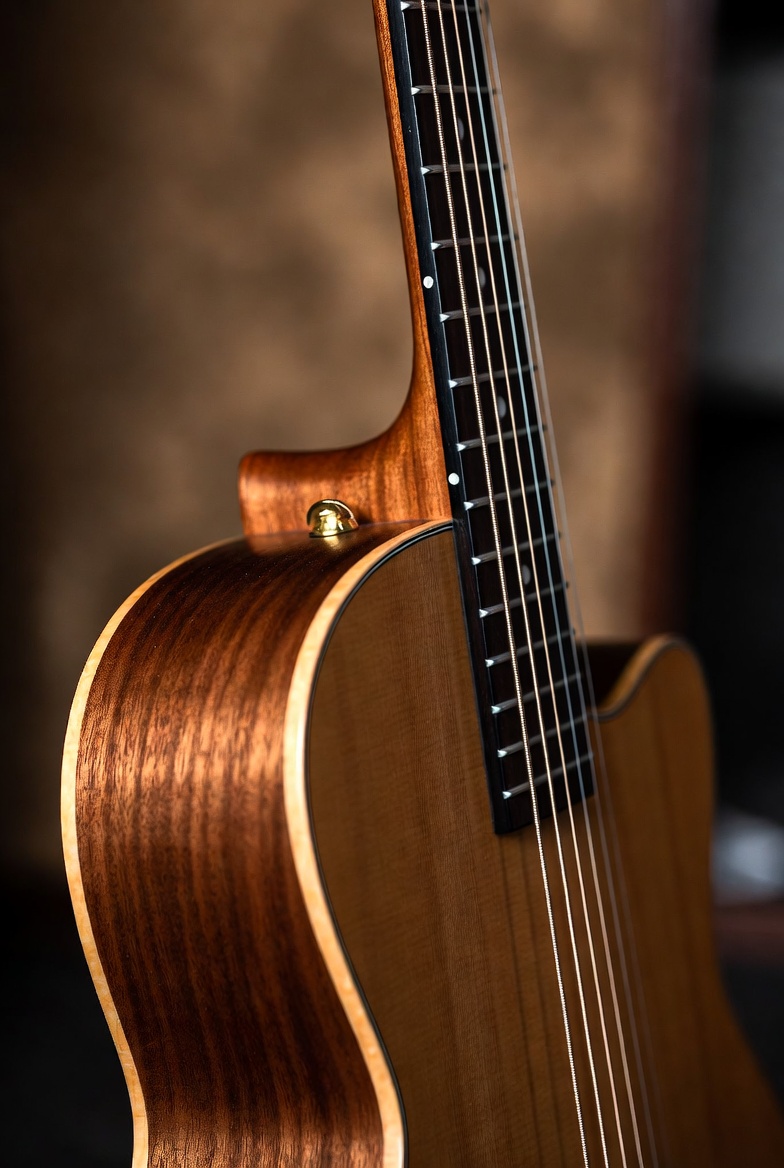 Fine wooden acoustic guitar close-up Fine wooden acoustic guitar close-up