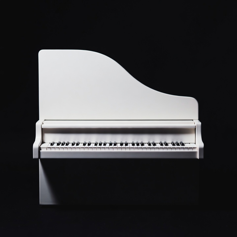 Elegant white piano against black background Elegant white piano against black background