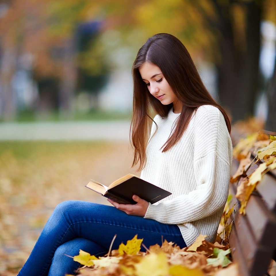 Young woman reading in autumn park Young woman reading in autumn park