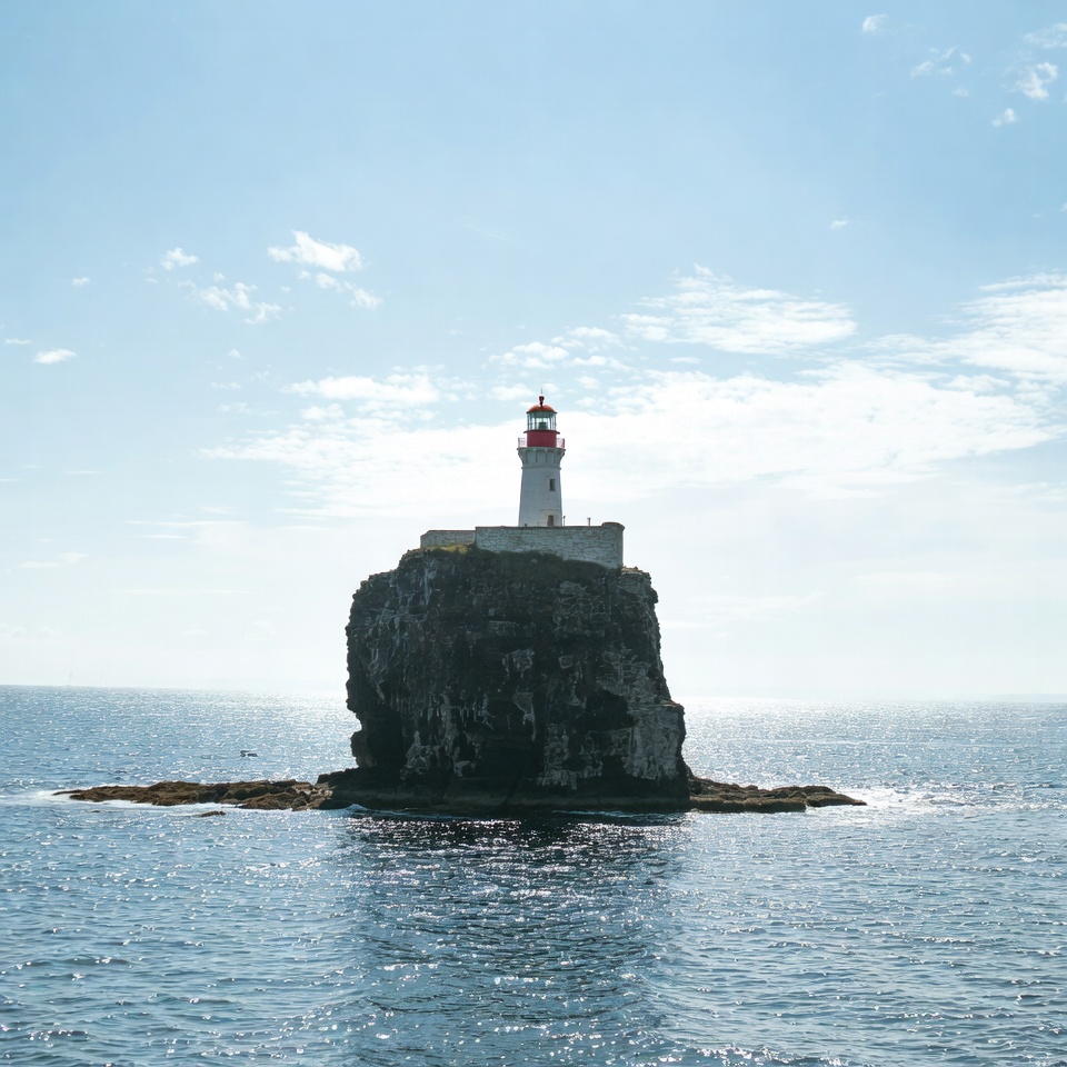 Lighthouse standing on a rock in the ocean Lighthouse standing on a rock in the ocean