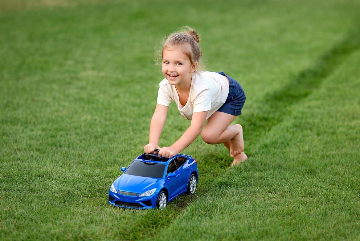 Child playing with toy car outside Child playing with toy car outside