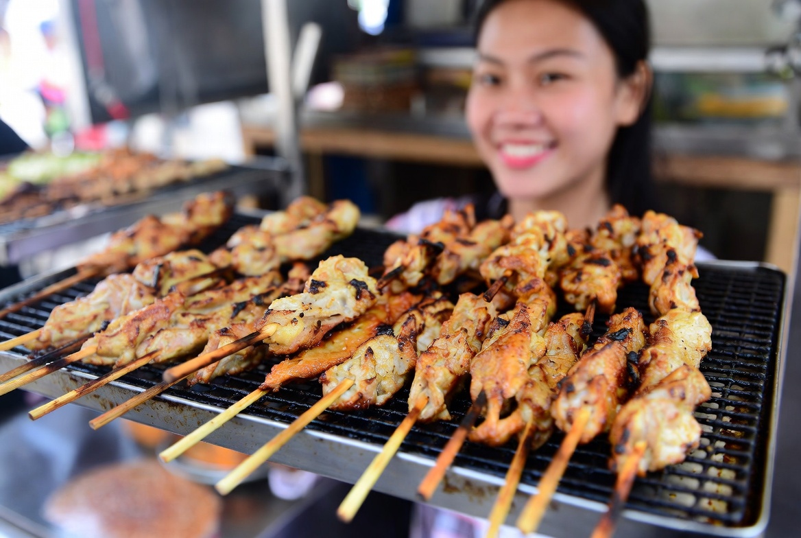 Grilling skewers at street market Grilling skewers at street market