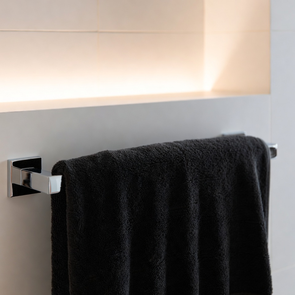 Black towel hanging on rack in bathroom Black towel hanging on rack in bathroom