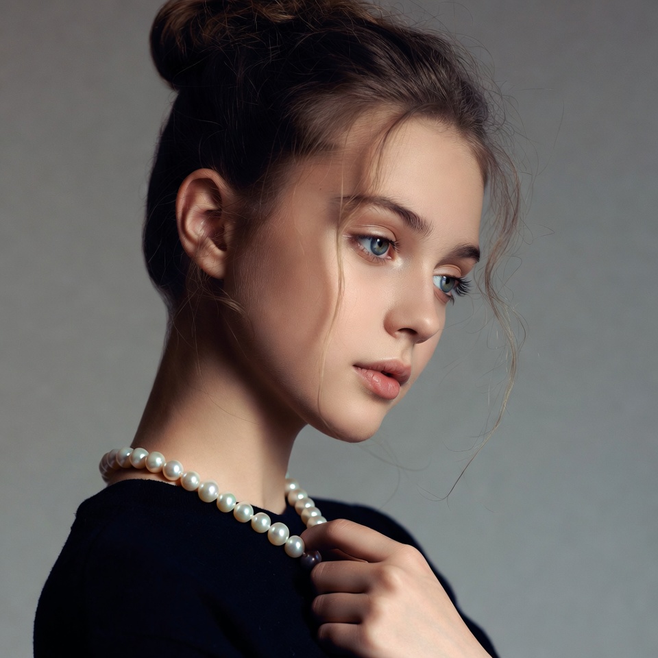 Young woman wearing pearls in portrait Young woman wearing pearls in portrait