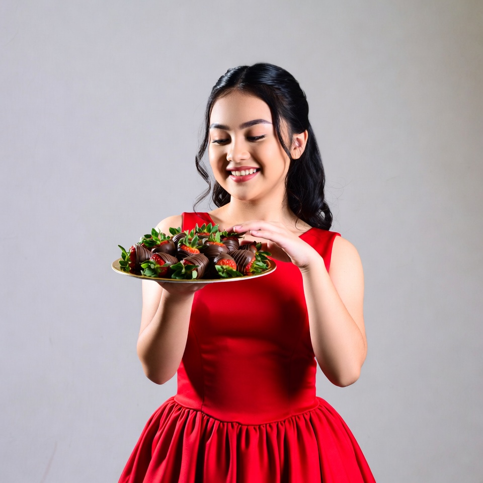 Woman holds plate of strawberries Woman holds plate of strawberries