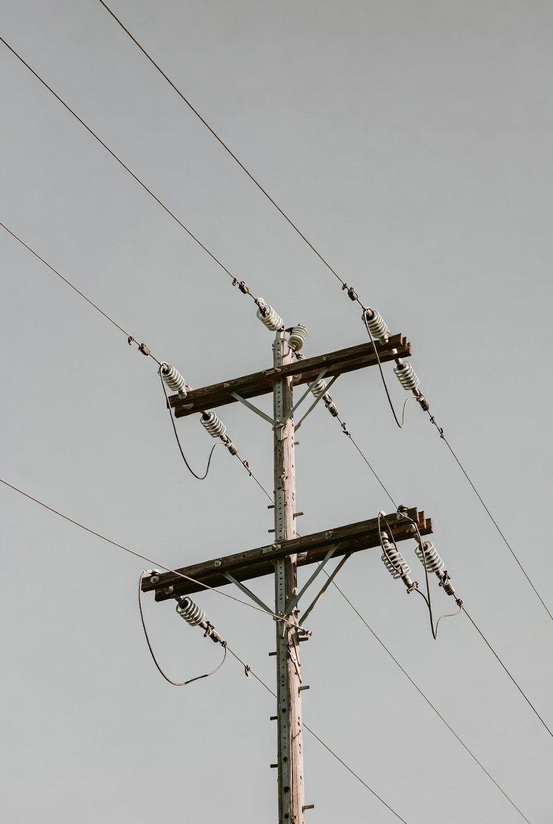 Utility pole with power lines against sky Utility pole with power lines against sky