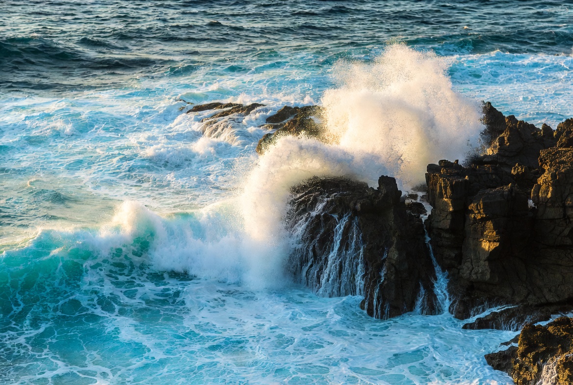 Waves crashing against rocky shore Waves crashing against rocky shore