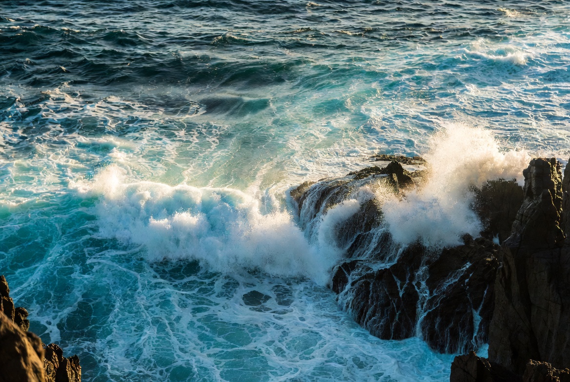 Waves crashing against rocky shore Waves crashing against rocky shore