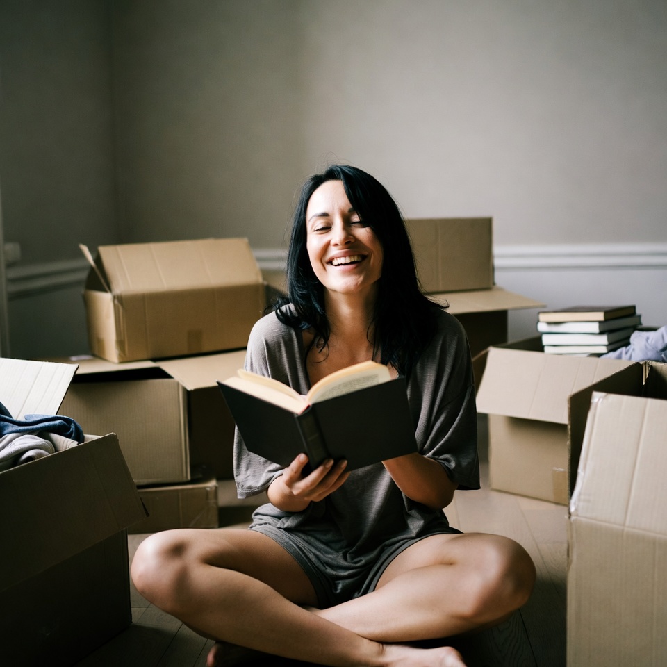 Reading in a new space surrounded by boxes Reading in a new space surrounded by boxes