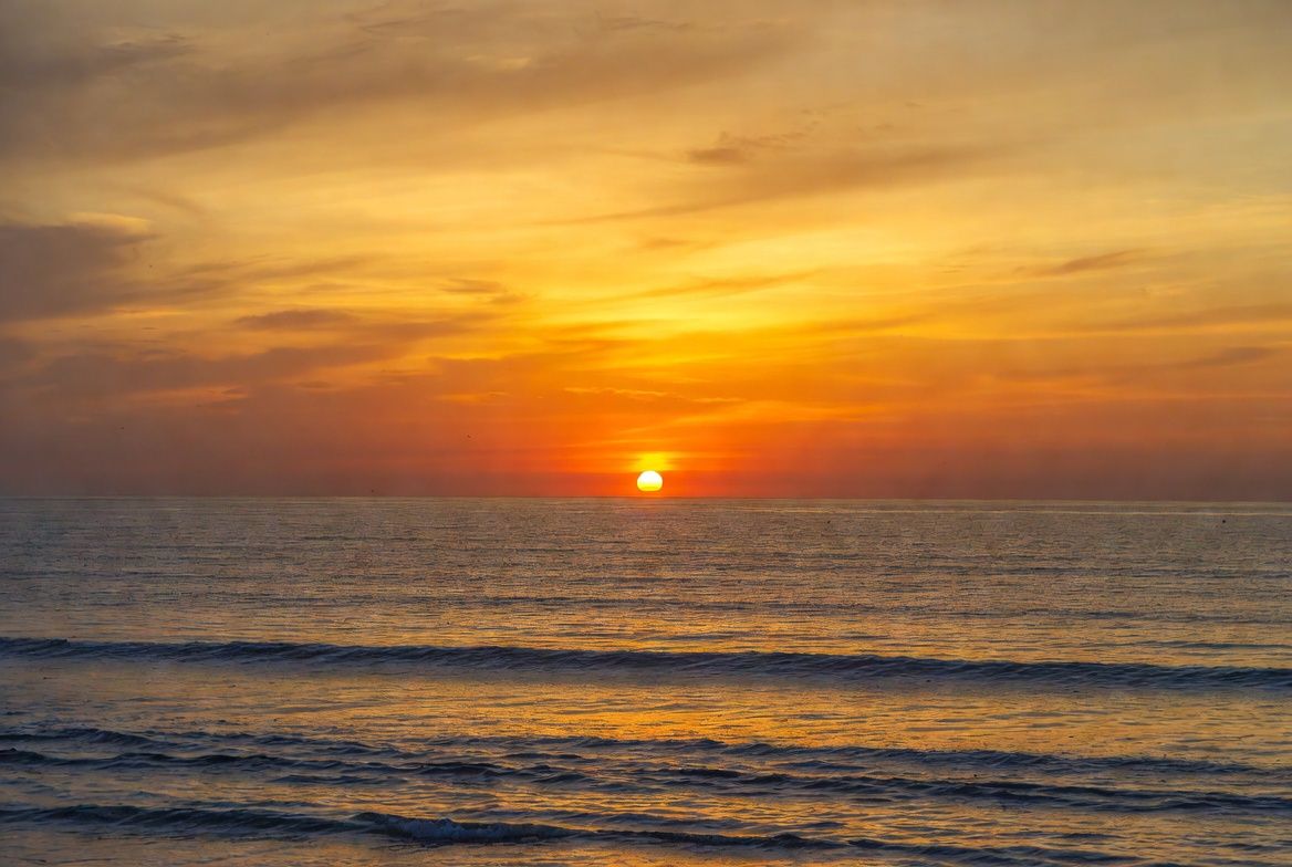 Sunset over the ocean waves Sunset over the ocean waves