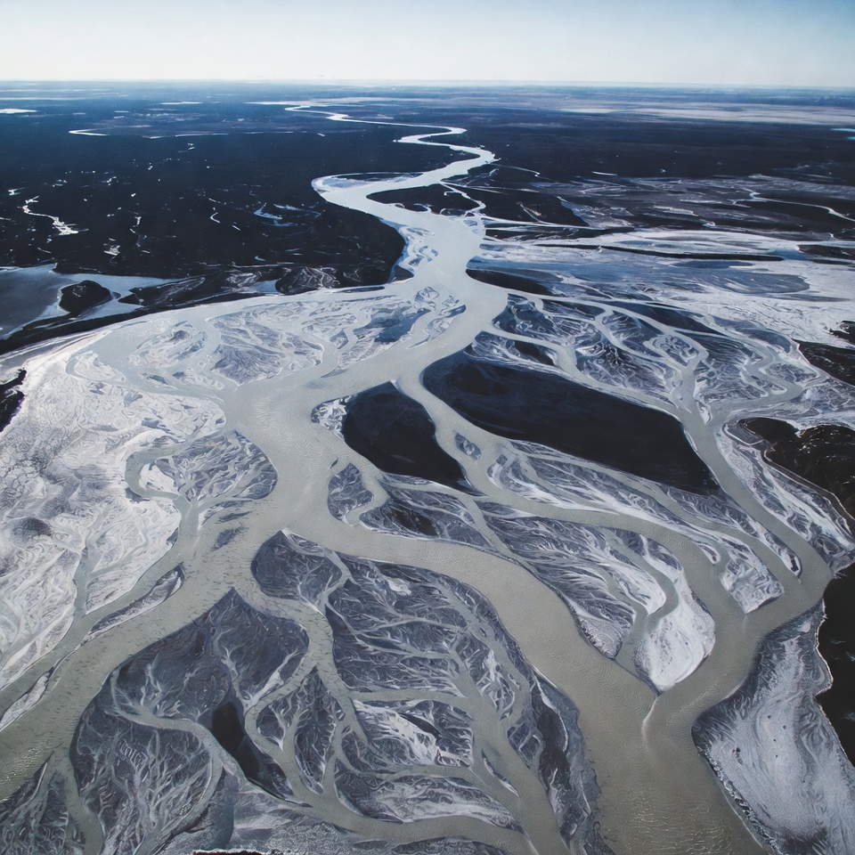 Winding river across frozen landscape Winding river across frozen landscape