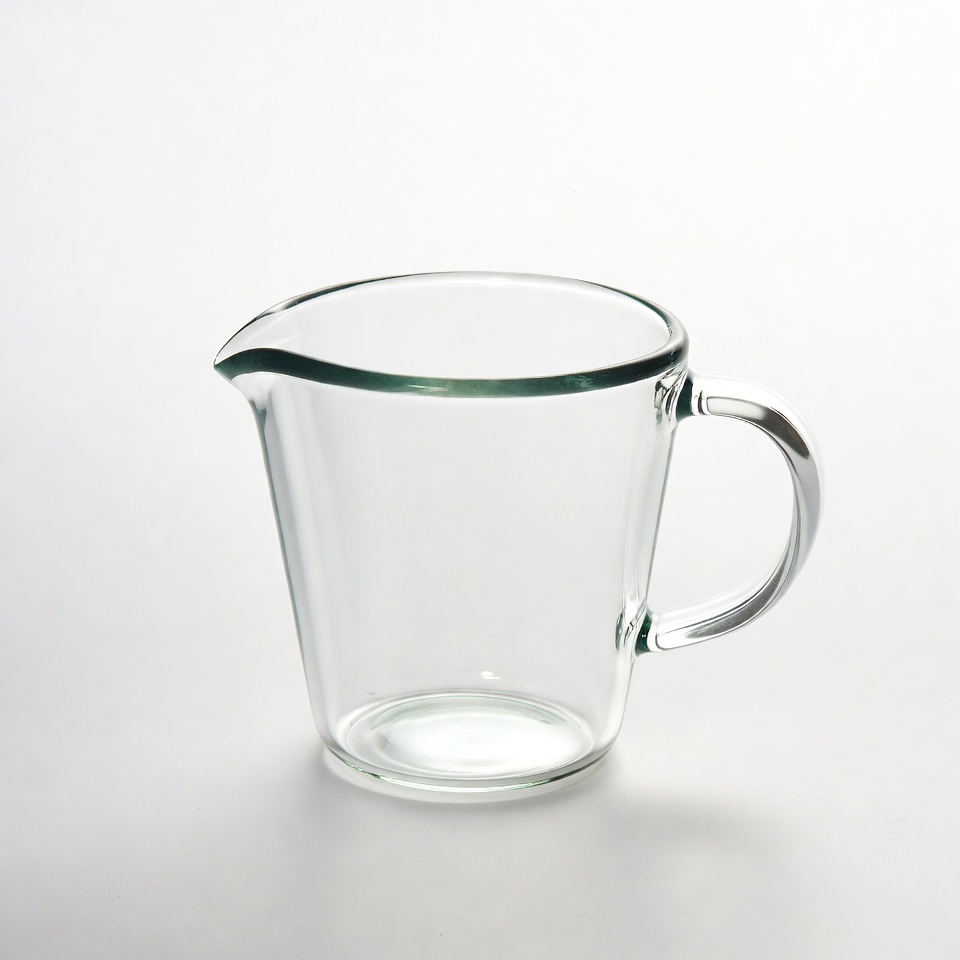 Clear glass measuring cup on a table Clear glass measuring cup on a table