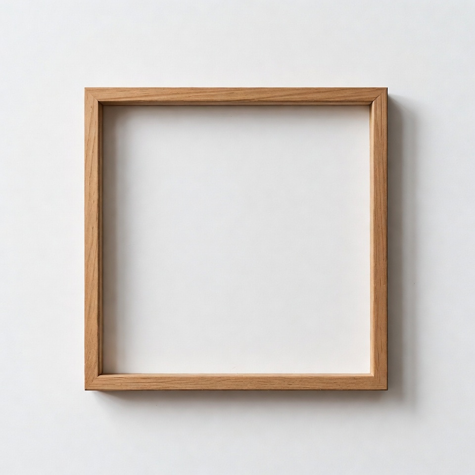 Empty wooden frame on white wall Empty wooden frame on white wall