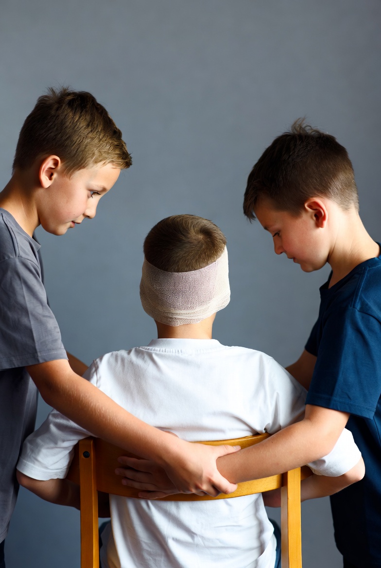 Boys help friend with head injury Boys help friend with head injury
