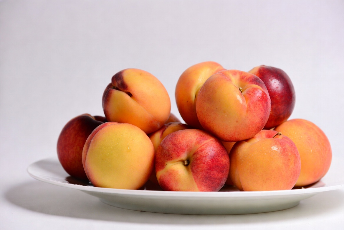 Fresh peaches on a white plate Fresh peaches on a white plate