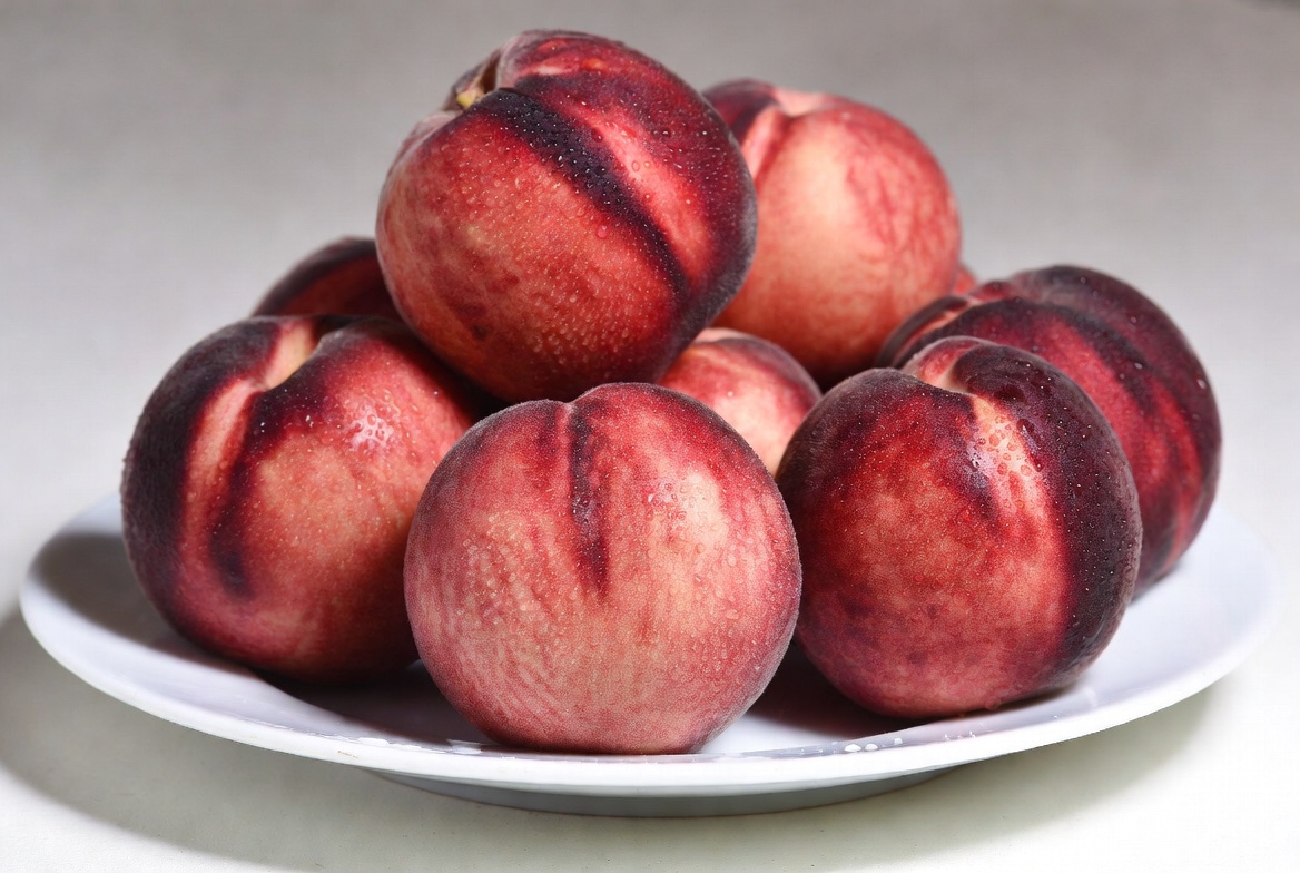 Fresh peaches on a white plate Fresh peaches on a white plate